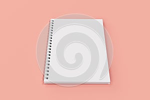 Closed notebook spiral bound on red background