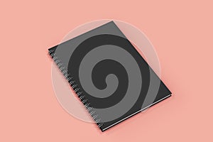 Closed notebook spiral bound on red background