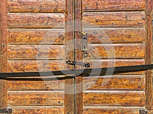 Closed rustic barn doors. brown weathered natural wood texture