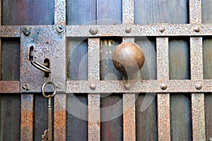 Closed old rusty padlock on a wooden door