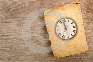 Closed old softcover book with retro clockface photo
