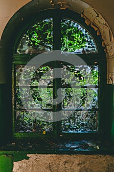 Closed old window with destroyed glass