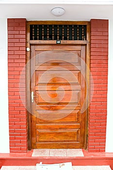 Closed ornate wood door of an upscale home, accented with an woo