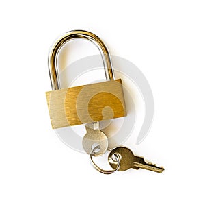 Closed padlock with keys isolated on white background. Locked yellow brass padlock closeup. The key is inserted into the lock.