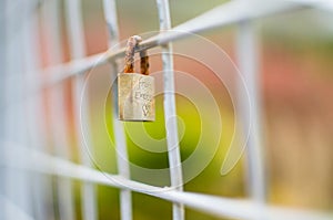 Closed Padlock Locked onto Square Fence with Exteme Shallow focu