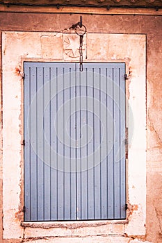 Closed, pair of, colorful, blue, wood, window shutters and iron chain