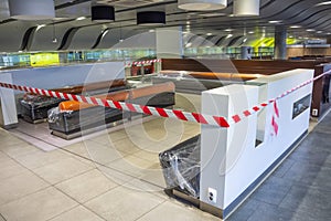 Closed places of a public catering tables and seats for people are fenced with a restrictive tape, are packed in a film.