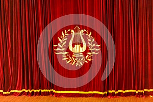 Closed red curtain with yellow lira sign on it background