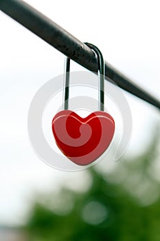 The closed red padlock in the form of heart