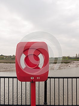 A closed red and white safety buoy box at the seaside seafront d