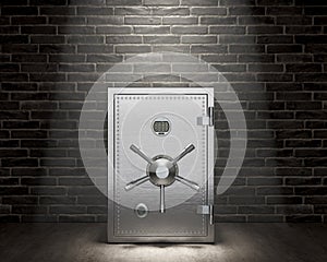 Closed and reliable steel safe in a dark room under the light,