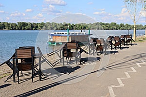 Closed restaurant by the river empty chairs and tables