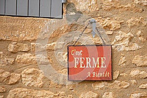 Closed see you soon french text means c`est ferme a bientot in france language on wall store text sign board on facade shop