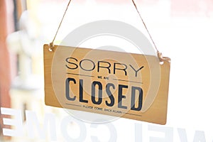 Closed shop sign - Sorry we`re closed sign hanging on cafe glass door