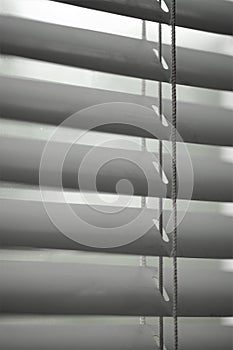 Closed shutters and rope closeup. Jalousie background
