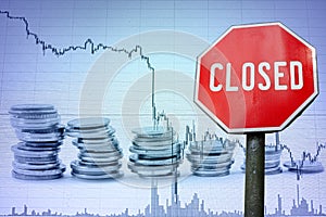 Closed sign on economy background - graph and coins