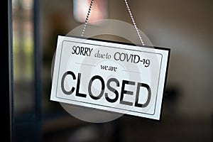 Closed sign hanging on door of cafe due to Covid-19