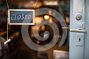 Closed - sign hanging on glass door