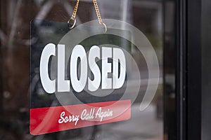 Closed sign hanging on the glass door