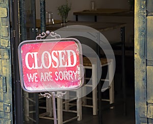 Closed sign outside a shop window.