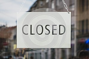 Closed sign on shop entrance door