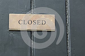 Closed sign in a wooden door