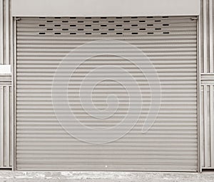 Closed steel shutter door of warehouse, storage or storefront for background and textured