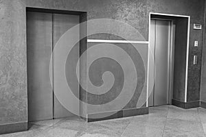 Closed stylish elevator doors in clean hall