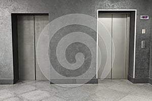 Closed stylish elevator doors in clean hall