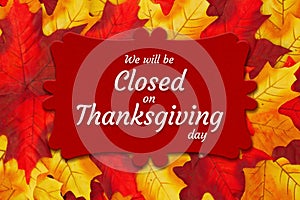 Closed Thanksgiving Day sign with autumn leaves