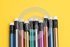 Closed up of colorful pencil with eraser on solid yellow background with copy space using as writing, mistake and correction or photo