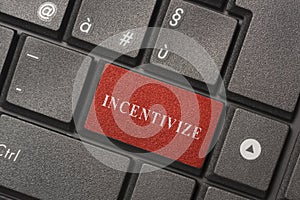 Closed up computer keyboard with word INCENTIVIZE
