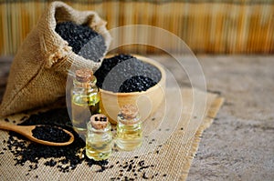 Closed up dry organic black sesame seed oil in glass bottle