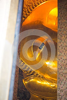 Closed up face from window of Reclining Buddha gold statue. Wat Pho