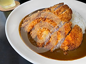 Closed up of Japanese curry rice with fried pork, serving on white plate, Japanese traditional food