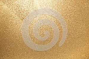 Closed up of metallic gold glitter texture background