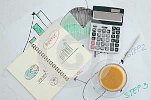 Closed up and soft focus on pen laying on paperwork with calculator for summary income or profit at office desk