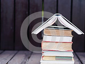 Closed up stack of books with wooden background
