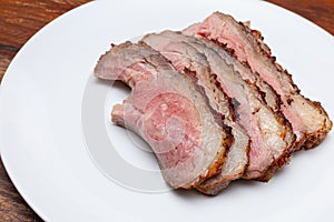 Closed up of tender smoked and grilled beef sliced on white plate. Beef sliced. Western traditional food. Black and white tone