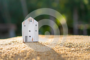 Closed up tiny home model on green grass with sunlight background