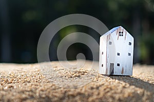 Closed up tiny home model on green grass with sunlight background