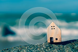 Closed up tiny home models on sand with sunlight and beach