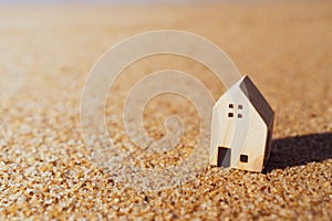 Closed up tiny home models on sand with sunlight and beach