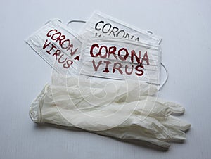 Closed up to face mask with reD CORONAVIRUS inscription and sterilized gloves