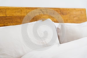 Closed up of white comfy pillow on the bed. Minimalist bedding and living space.