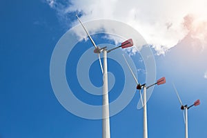 Closed up Wind turbine generating electricity on blue sky with clounds,Windmills for electric power ecology concept