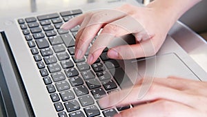 Closed up on woman hand is typing on Thai and English alphabet on laptop keyboard