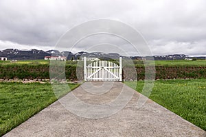 Closed white gate with mountains in the background