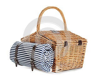 Closed wicker picnic basket with blanket