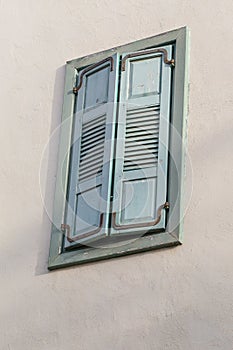 Closed window frame from outside on the wall.